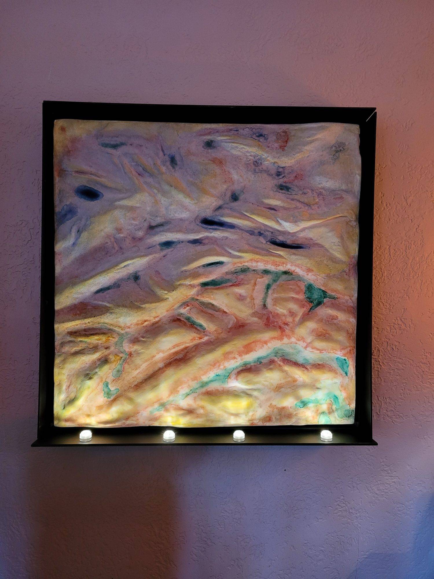watercolor painting on 3D plaster mountains with lights shining from the bottom inside of a shadowbox