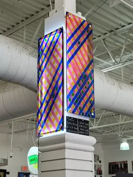 Two 12" x 30" resin art paintings mounted on column at art supplies store in Omaha, NE.