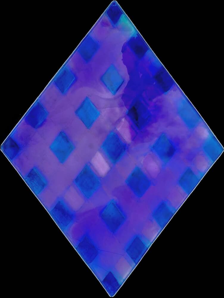 purple diamond color is reflected and refracted from the glossy surface of the resin slab over a white paper.
